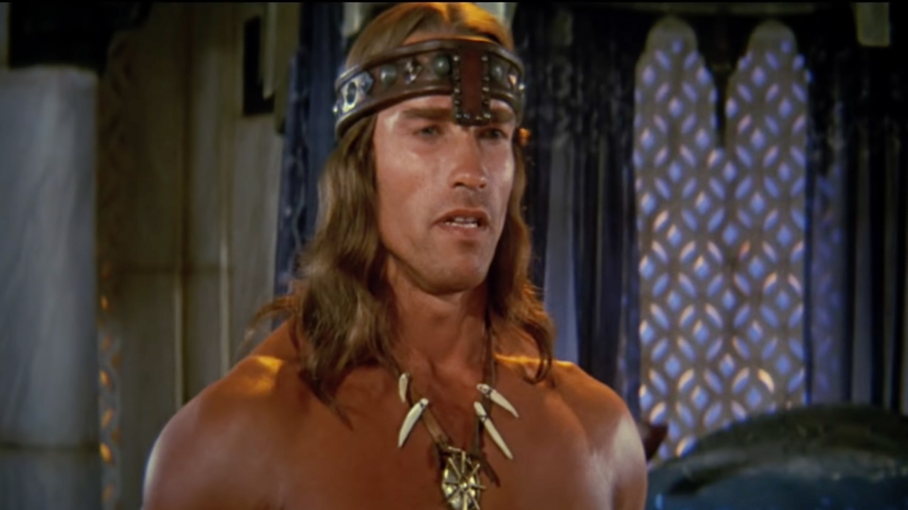 See Arnold Schwarzenegger Use His Conan The Barbarian Sword To Open His First Box Of His Book